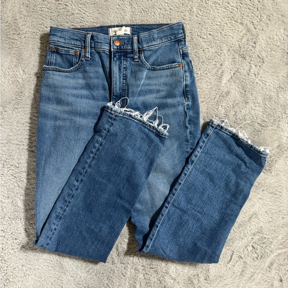 Madewell dark wash jeans with distressing on the bottom. Called slim Demi boot